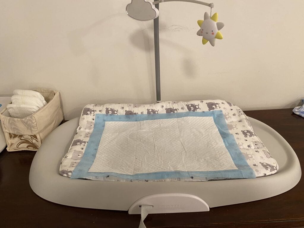 Disposable diaper changing pad