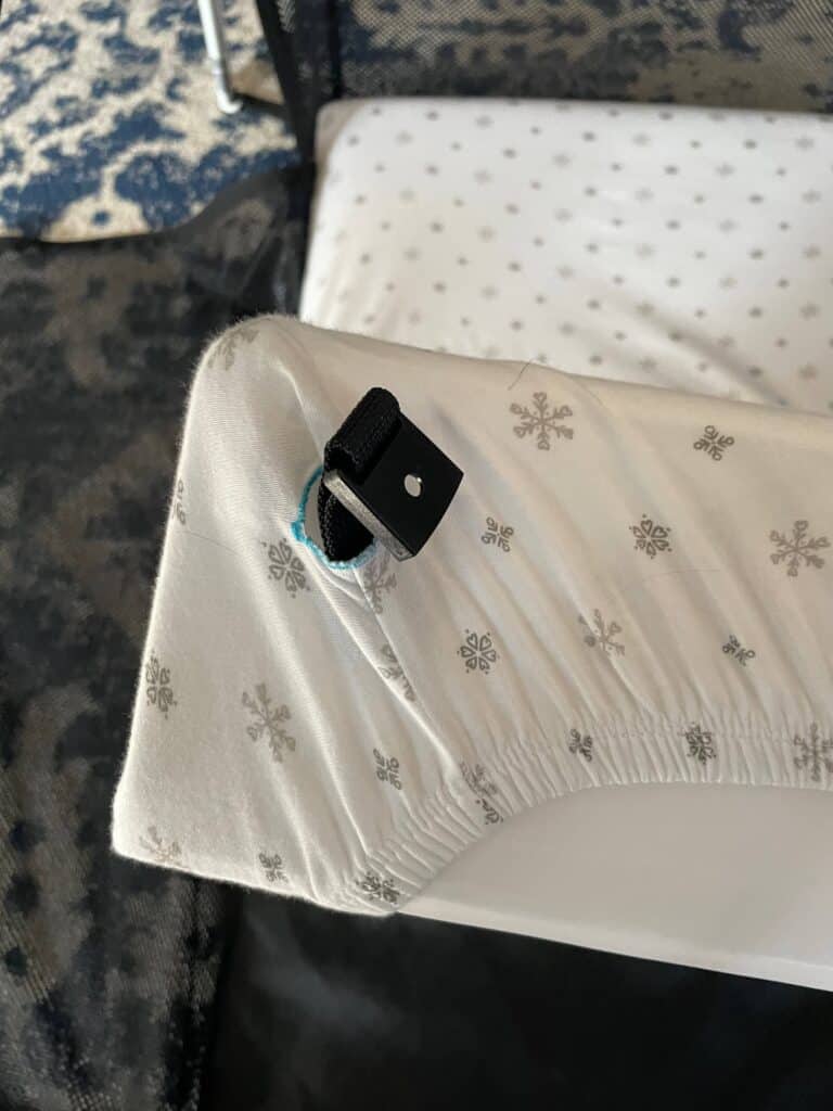 Guava Lotus Travel Crib clip through sheet on mattress 