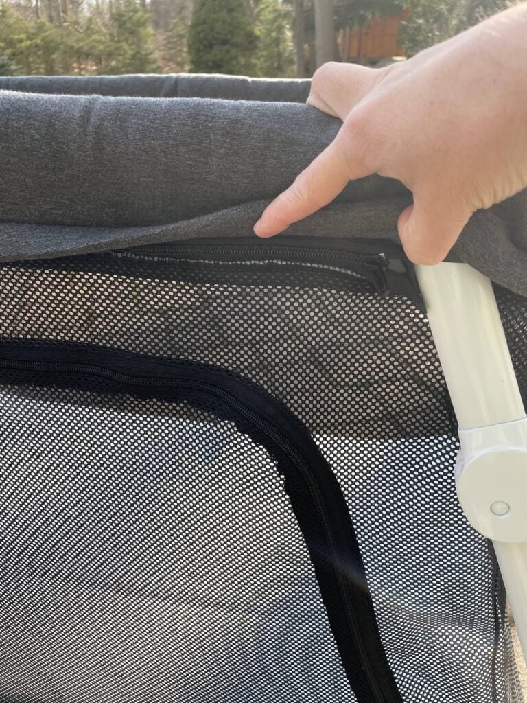 Zippers revealed underneath padding of Guava Lotus Travel Crib