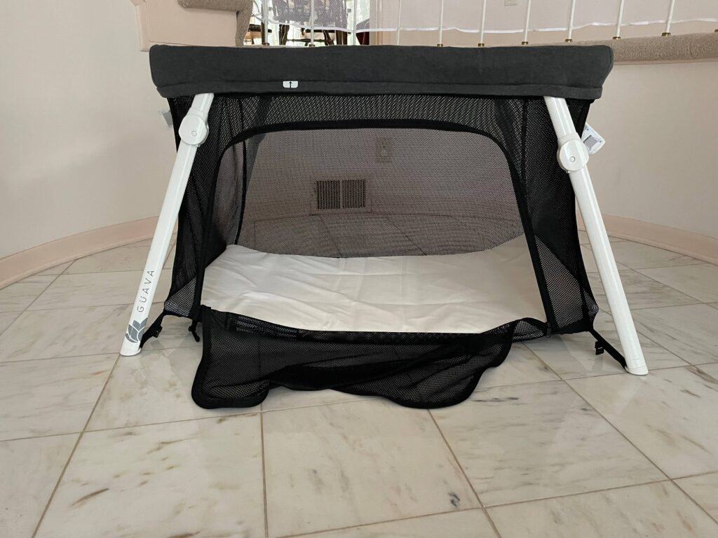 Guava Lotus Travel Crib set up with side panel open