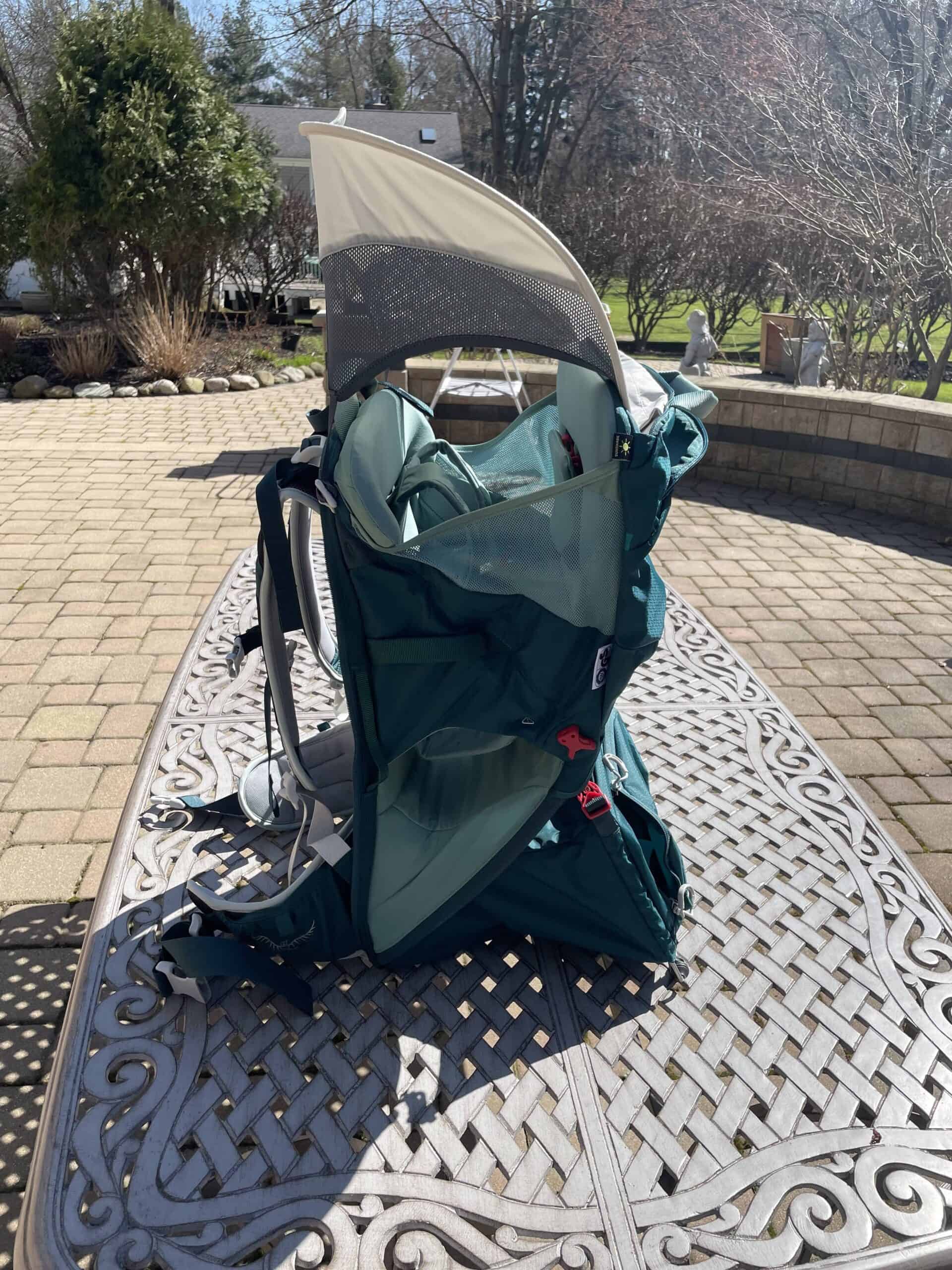 Fully deployed and connected sunshade on Osprey Poco LT show from side angle where it lacks ample sun protection. 