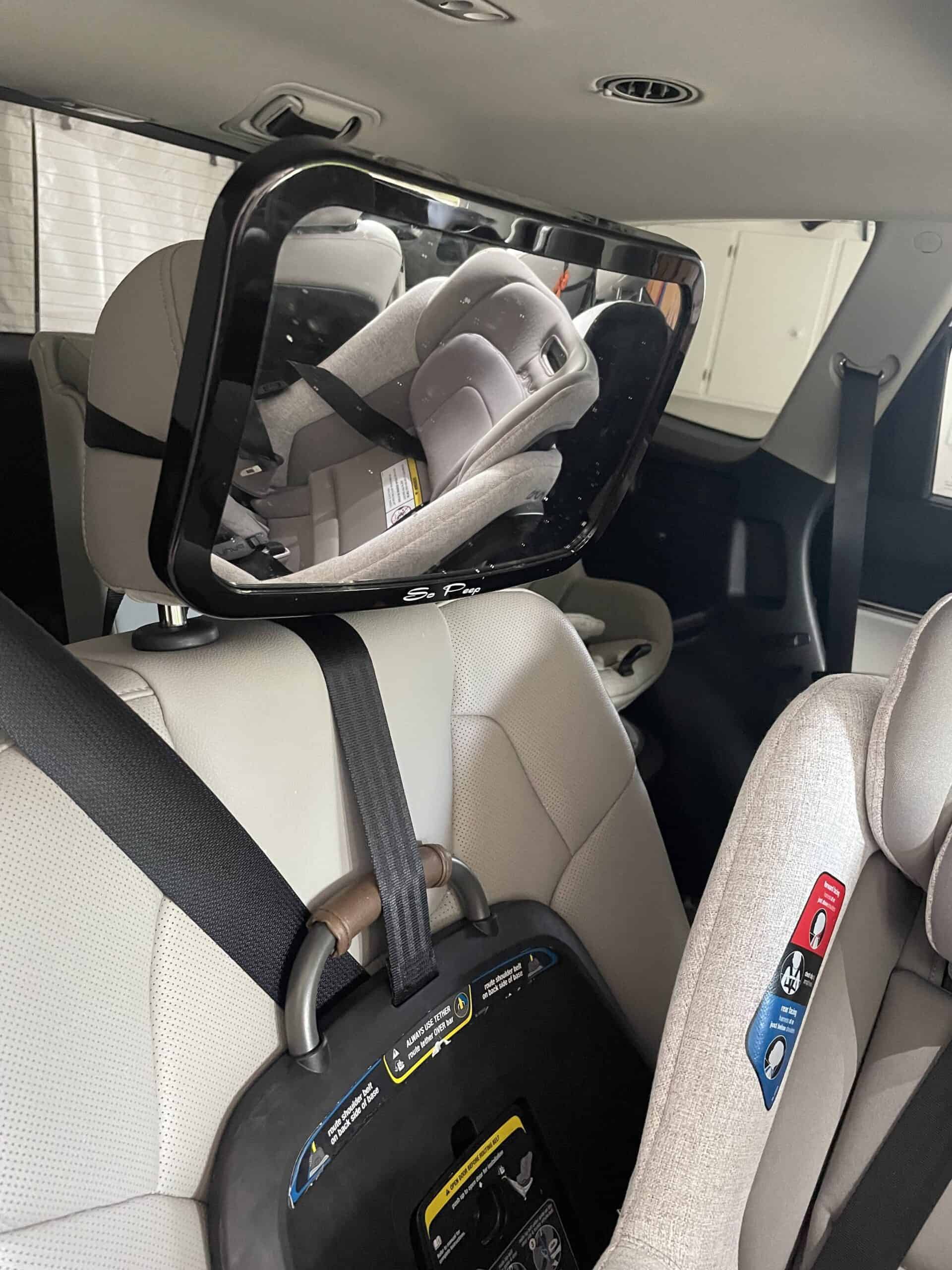 Child car seat mirror attached to the headrest in vehicle