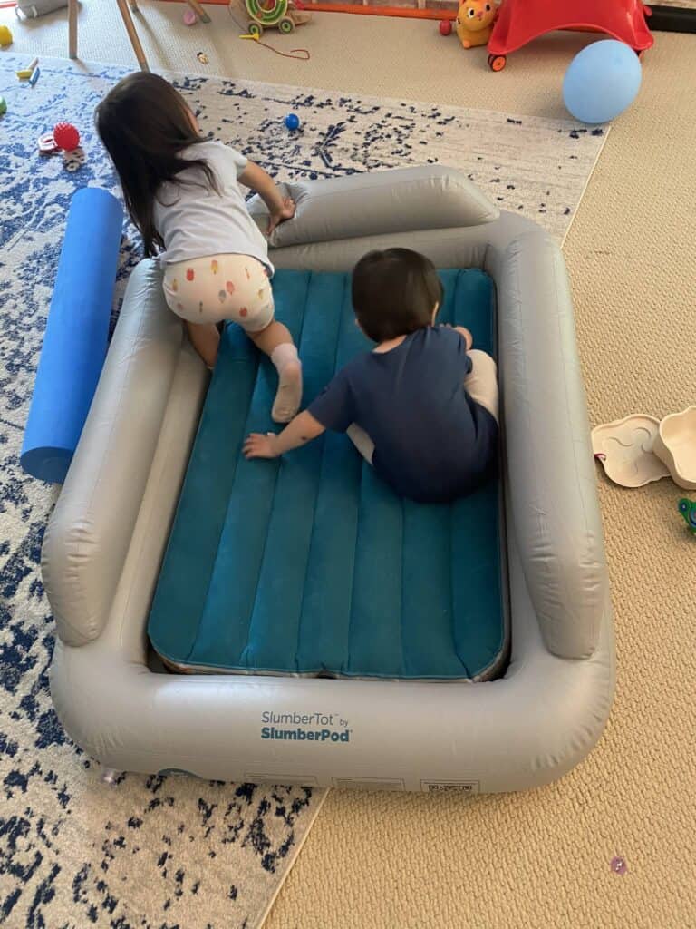 Slumber Tot with two toddlers playing in it