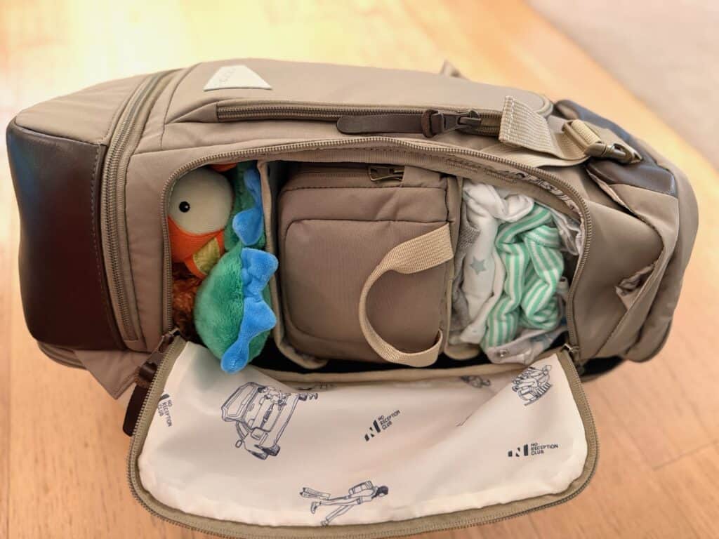 Pack cloth on top of No Reception Club bag for babies